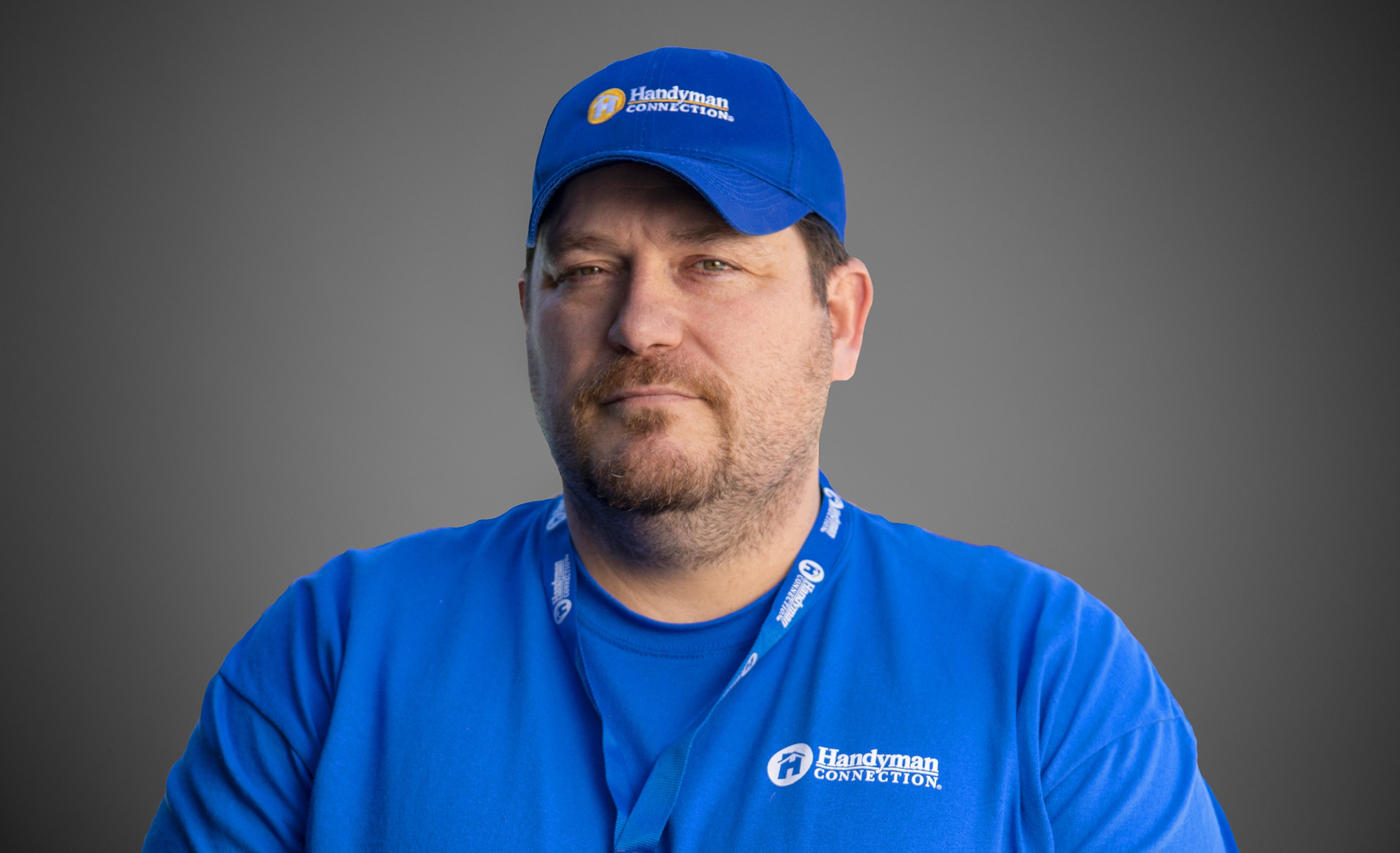 Picture of a man in a blue shirt and blue ball cap.