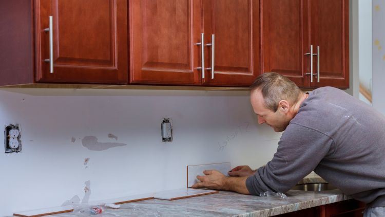 Tile grouting applying grout to the joint tiles