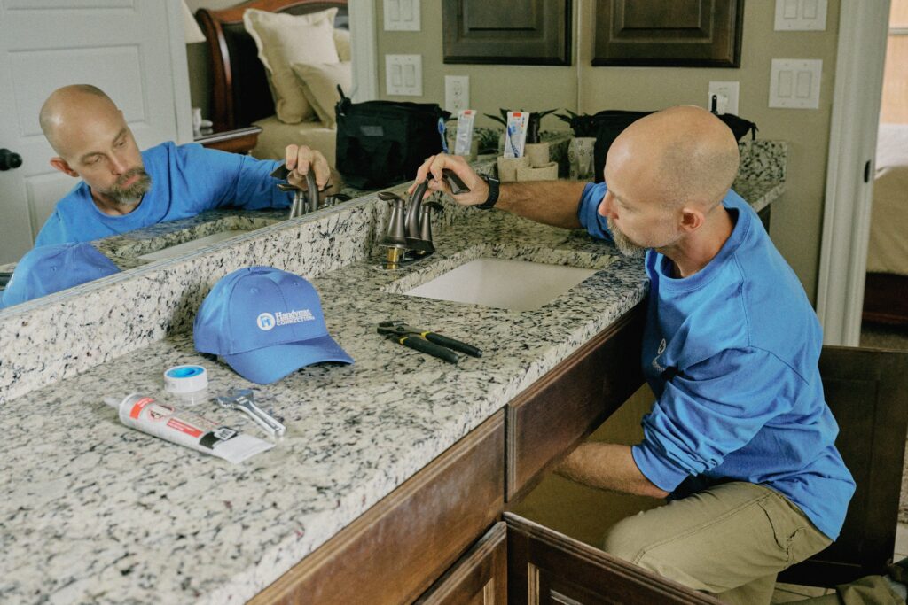plumbing handyman in Salt Lake City working on customer bathroom sink