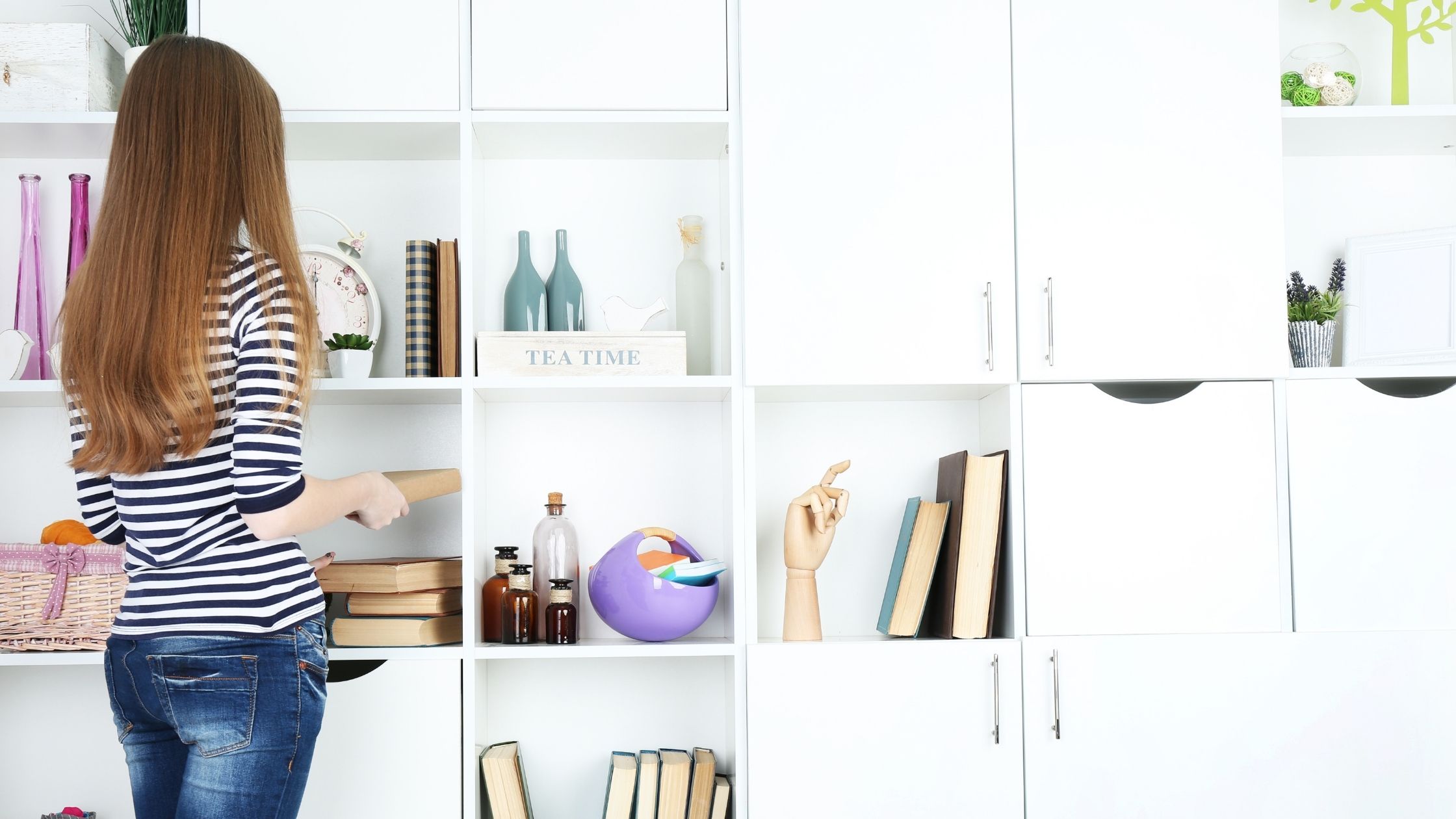 Woman standing next to shelving unit