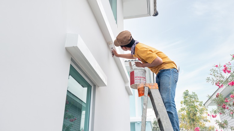 craftsperson doing exterior painting work for the a home