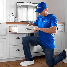 maintenance handyman installing new kitchen cabinets