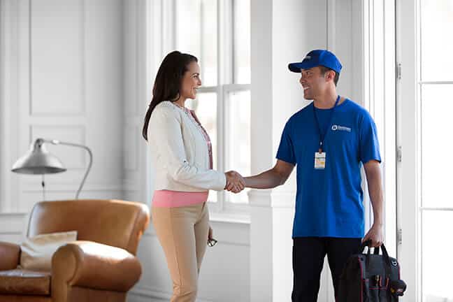 handyman shaking hands with customer after completion of remodeling project