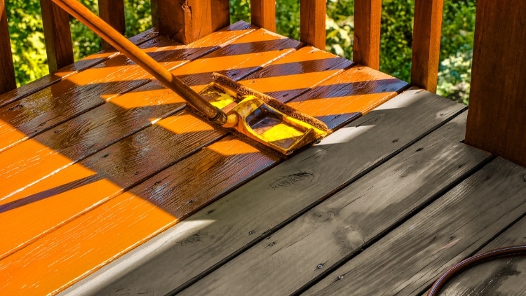 staining wooden deck with paint roller