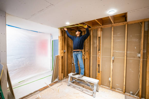 one of our craftsmen helping to install new drywall in a home kitchen