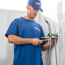 handyman installing new plumbing fixtures in bathroom