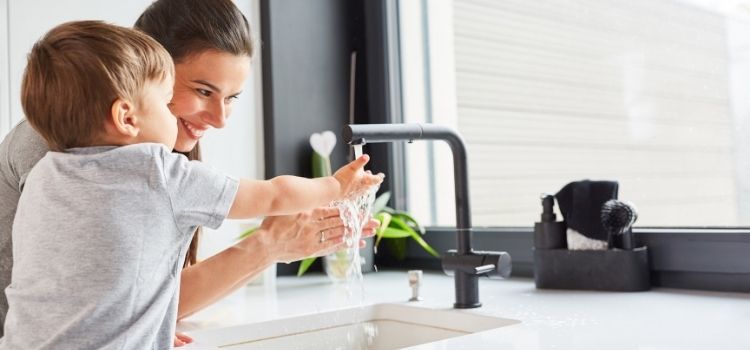 Mother and son washing hands