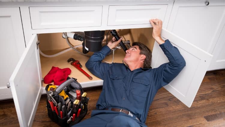 a man doing plumbing services