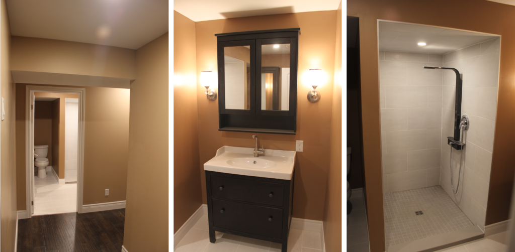 added bathroom painted in brown tones with white tiled shower, dark brown vanity with white sink and matching mirror, light fixtures on both sides of the mirror plus the added toilet. 