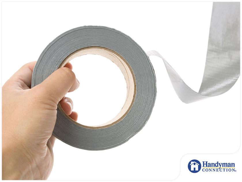 https://handymanconnection.com/mason/wp-content/uploads/sites/29/2021/05/2062-1618629380-person-holding-a-roll-of-duct-tape.jpg
