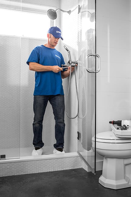 handyman installing shower fixtures