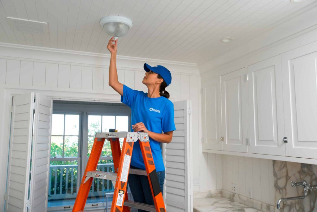 handyperson installing electric light