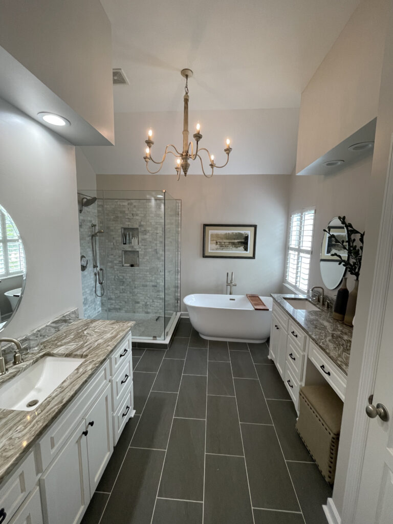 completed bathroom remodel done by our craftsmen with new tile flooring, fixtures, and bathtub installed