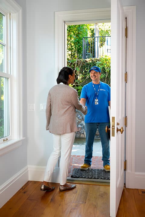 handyman from Handyman Connection shaking hands with homeowner 