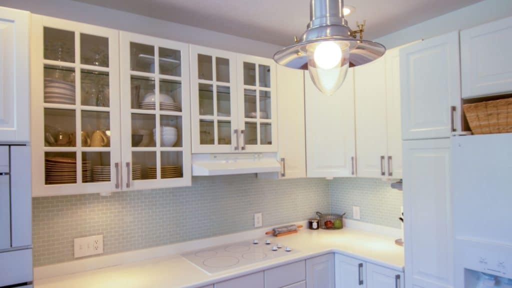 A kitchen remodel featuring white cabinets and a white refrigerator, creating a clean and modern look.