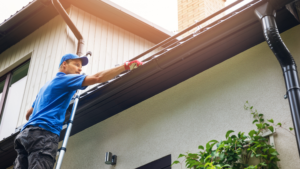 handyman performing gutter maintenance