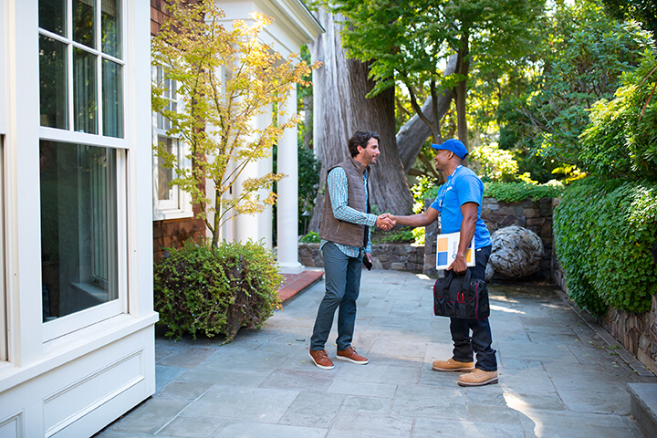 handyman shaking hands with customer