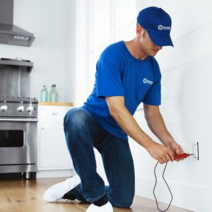 handyman testing electrical outlet