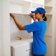 handyperson installing home storage shelves