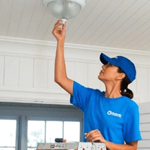 handyperson installing new light fixture