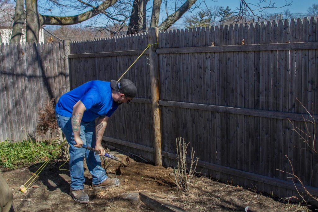 handyman in Loves Park, IL, installing a new fence post