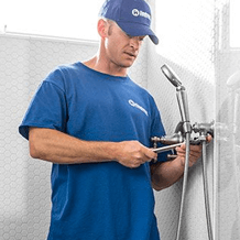 handyman installing shower fixtures