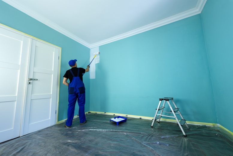 handyman painting interior wall in Prairie Village home