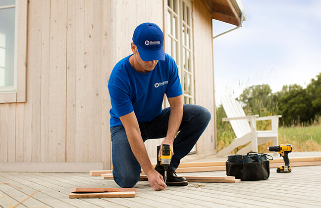 handyman installing new deck boards for home