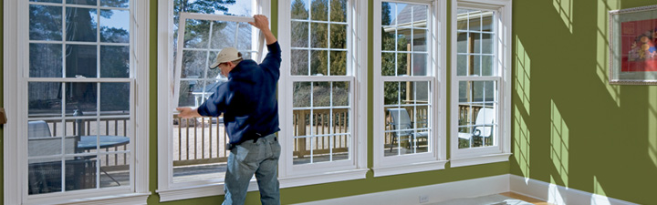 handyman from Handyman Connection installing windows in home