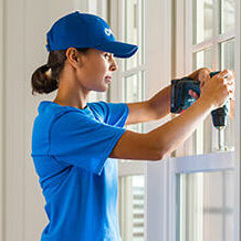 handyperson installing new windows inside home