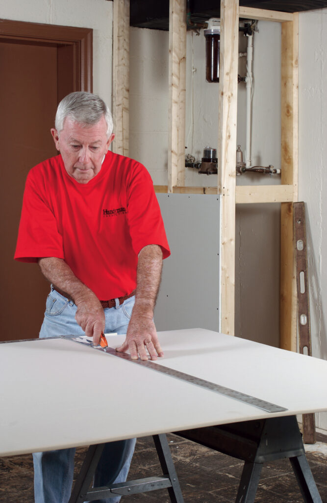 drywall handyman in Watkins, CO, cutting drywall for a project