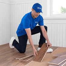 craftsman installing new hardwood flooring