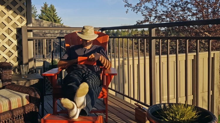 man relaxing on the deck