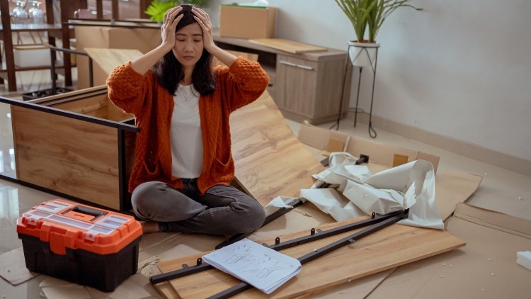 frustrated woman assembling new furniture