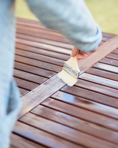 Applying Varnish to Wooden Deck