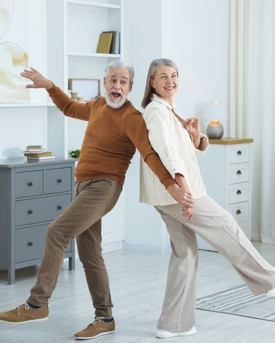 Happy Senior Couple Dancing Together at Home