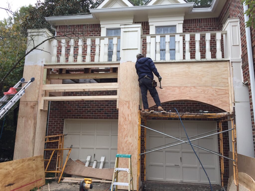 handyman helping repair exterior trim of a home in Maitland, FL