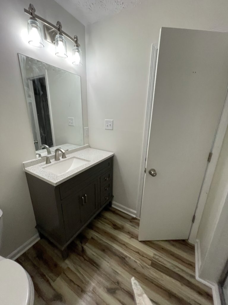 new bathroom sink and mirror installed by our craftsmen in Roswell, GA