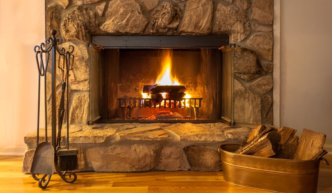 https://handymanconnection.com/wp-content/uploads/2018/11/stone-fireplace-with-logs-burning-in-a-residential-home-picture-id1166435537.jpg