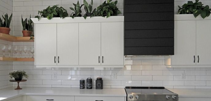 White Cabinets Against White Subway Tile Walls in Small Kitchen