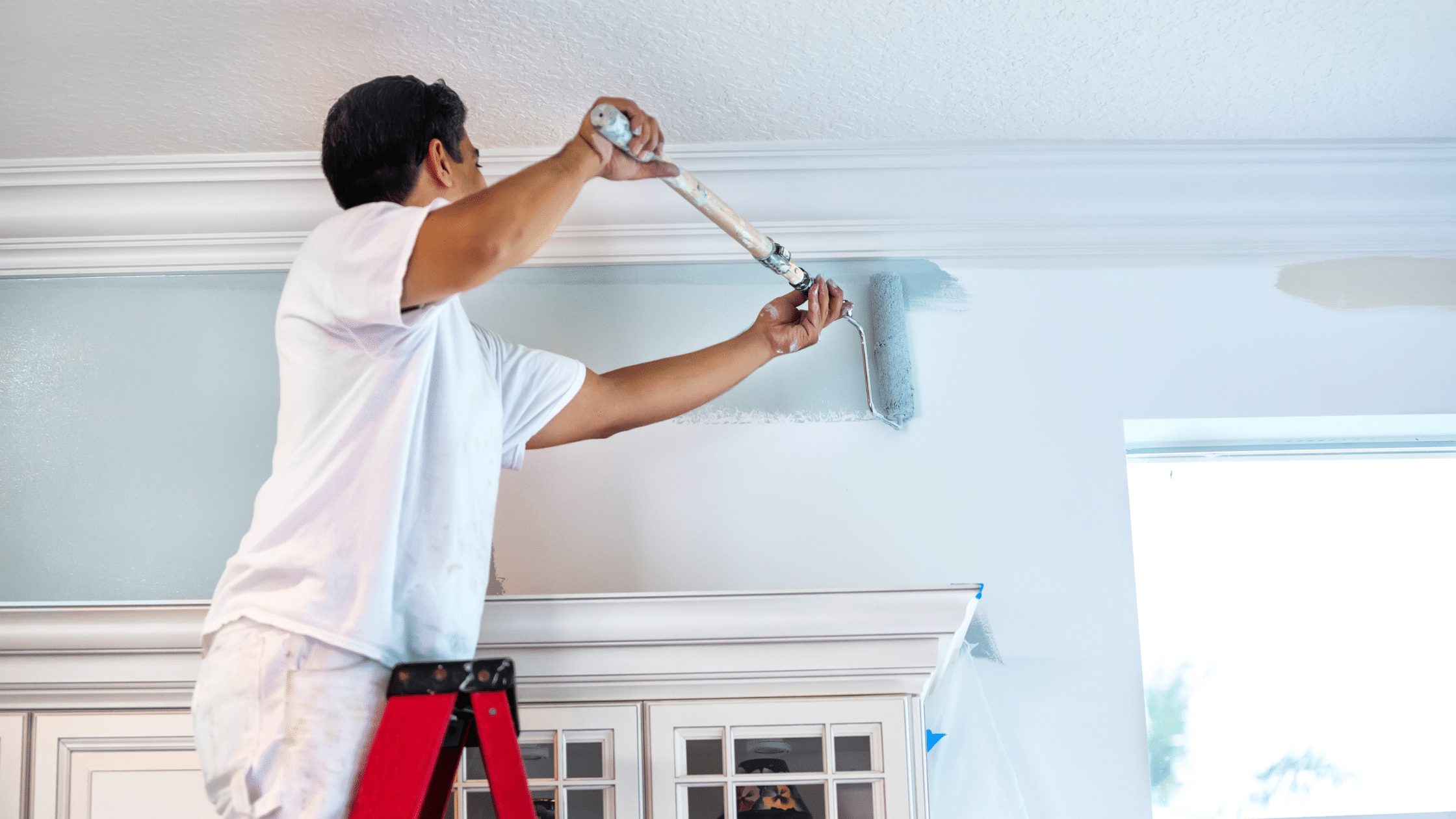 man painting inside a home