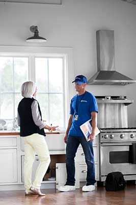 homeowner and handyman talking in kitchen